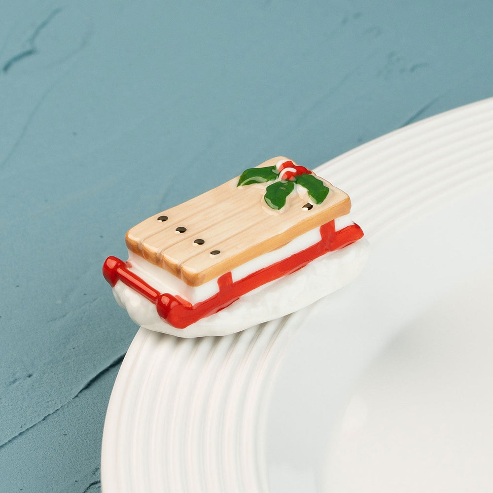 Ho Ho Whoa by Nora Fleming — hand-painted ceramic runaway red sled (alternate view)