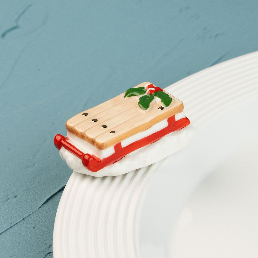 Ho Ho Whoa by Nora Fleming — hand-painted ceramic runaway red sled (alternate view)