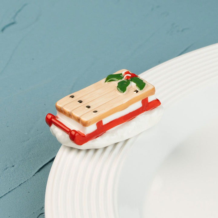 Ho Ho Whoa by Nora Fleming — hand-painted ceramic runaway red sled (alternate view)