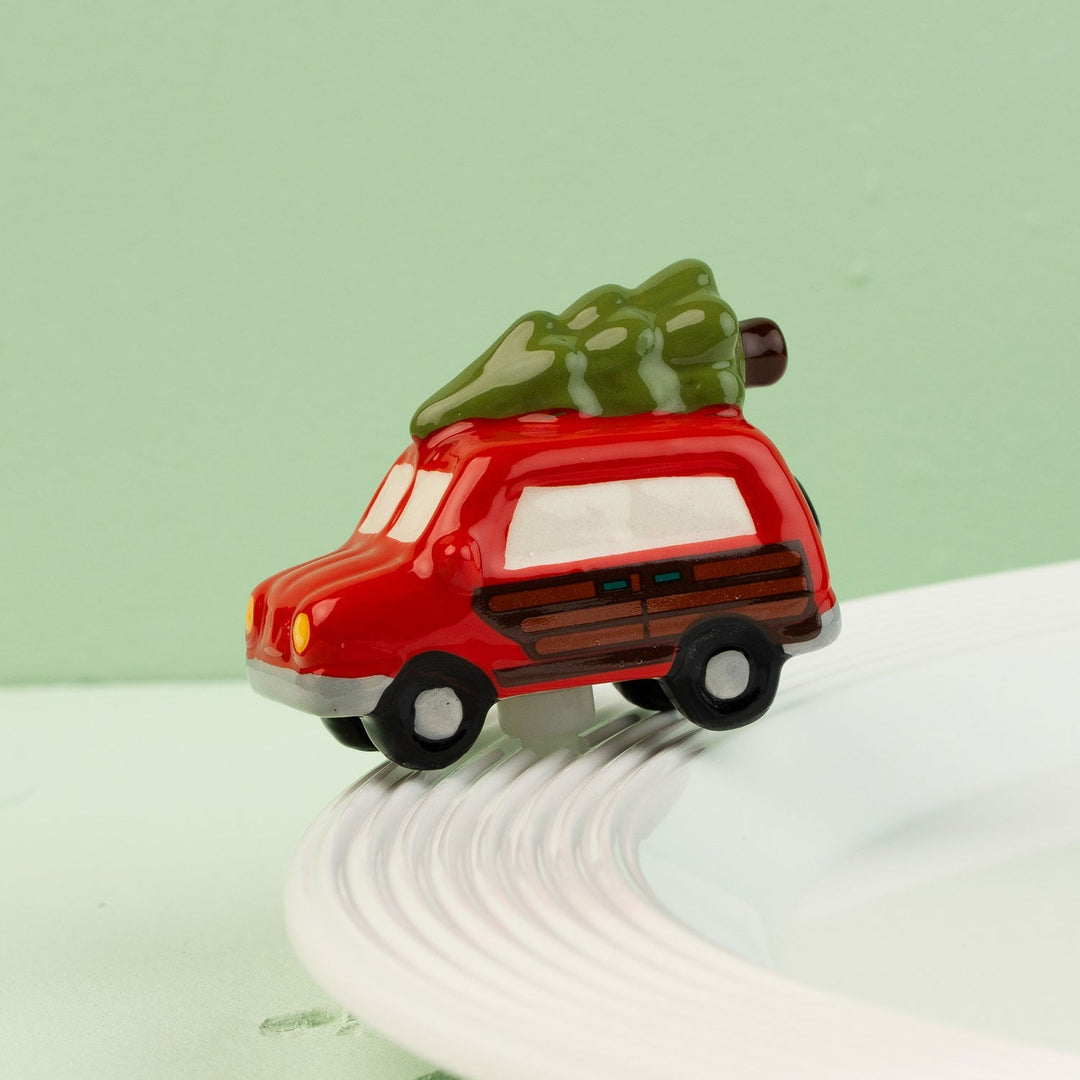 Just like the Griswold's Mini by Nora Fleming — hand-painted ceramic station wagon with the tree strapped on top