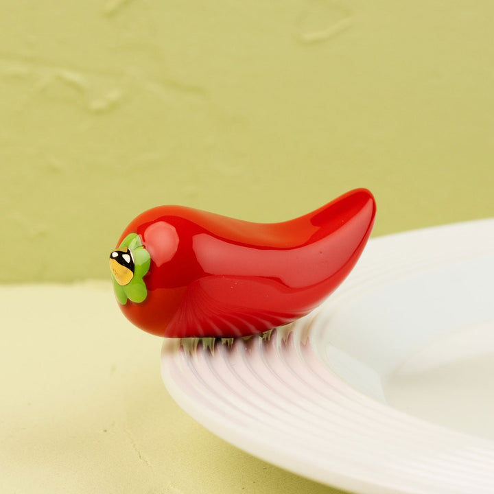 Red pepper Nora Fleming mini on a white plate